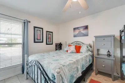 a bedroom with a bed and a window at 7131 Sunset Ave - Cottage by The Sea with pool in Panama City Beach