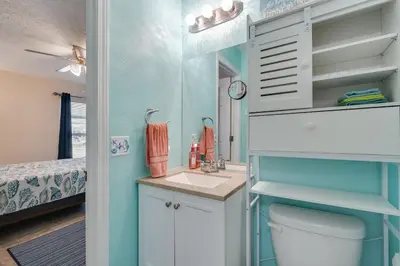 a small bathroom with a sink and a toilet at 7131 Sunset Ave - Cottage by The Sea with pool in Panama City Beach