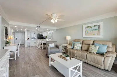 a living room with a couch and a table at Edgewater T1 #709 - Sleeps 6 Amazing gulf views! in Panama City Beach