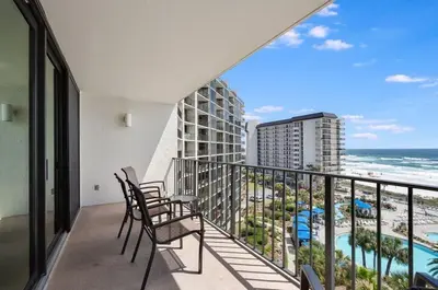 a balcony with chairs and a view of the ocean at Edgewater T1 #709 - Sleeps 6 Amazing gulf views! in Panama City Beach