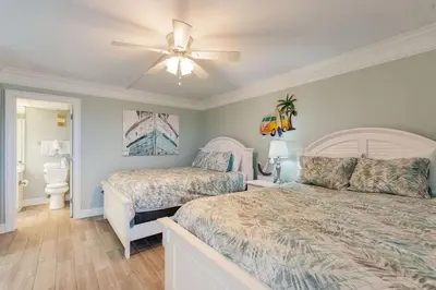 a bedroom with two beds and a ceiling fan at Edgewater T1 #709 - Sleeps 6 Amazing gulf views! in Panama City Beach