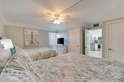 a bedroom with two beds and a ceiling fan at Edgewater T1 #709 - Sleeps 6 Amazing gulf views! in Panama City Beach
