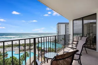 a balcony with chairs and a view of the ocean at Edgewater T1 #709 - Sleeps 6 Amazing gulf views! in Panama City Beach
