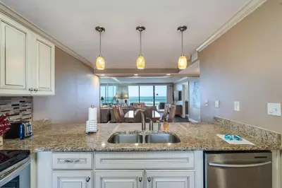 a kitchen with a sink and a view of the ocean at Edgewater Tower 1 #609 - Lagoon Tower - 2 BR 2 BA in Panama City Beach