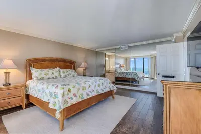 a bedroom with a large bed and a bathroom at Edgewater Tower 1 #609 - Lagoon Tower - 2 BR 2 BA in Panama City Beach