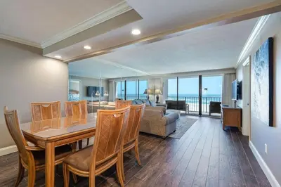 a living room with a table and chairs and a couch at Edgewater Tower 1 #609 - Lagoon Tower - 2 BR 2 BA in Panama City Beach
