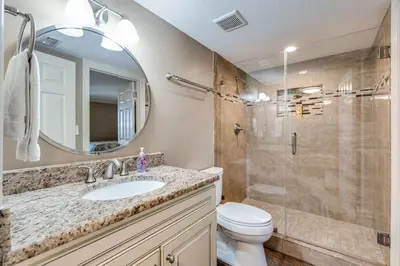 a bathroom with a toilet and a sink and a shower at Edgewater Tower 1 #609 - Lagoon Tower - 2 BR 2 BA in Panama City Beach