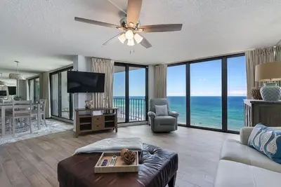 a living room with a view of the ocean at Edgewater T2 #911 Sleeps 10 with amazing sunsets! in Panama City Beach