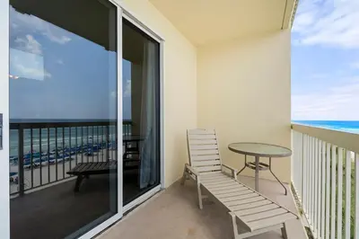 a balcony with a table and chair and the ocean at Celadon 307 1 BR 2 BA Oceanfront condo in Panama City Beach