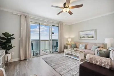 a living room with a couch and a ceiling fan at Celadon 1506 Beachfront 1 BR 2 BA sleeps 6 in Panama City Beach