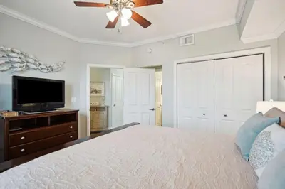 a bedroom with a bed and a flat screen tv at Celadon 1506 Beachfront 1 BR 2 BA sleeps 6 in Panama City Beach