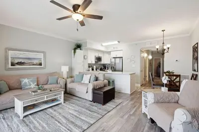 a living room with a couch and a ceiling fan at Celadon 1506 Beachfront 1 BR 2 BA sleeps 6 in Panama City Beach