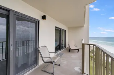 two chairs on a balcony with a view of the ocean at Commodore 605 3 BR 3 BA with 2 Beachfront Masters in Panama City Beach