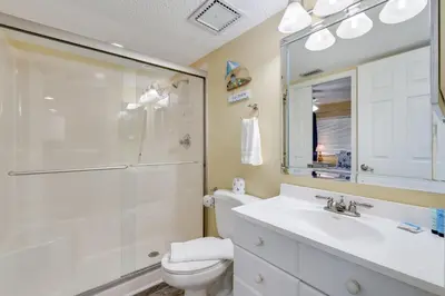 a bathroom with a shower and a sink and a toilet at Commodore 605 3 BR 3 BA with 2 Beachfront Masters in Panama City Beach