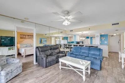 a living room with a couch and a table at Commodore 605 3 BR 3 BA with 2 Beachfront Masters in Panama City Beach