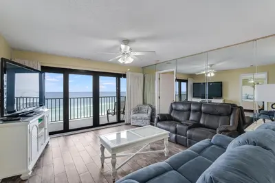 a living room with a couch and a tv at Commodore 605 3 BR 3 BA with 2 Beachfront Masters in Panama City Beach