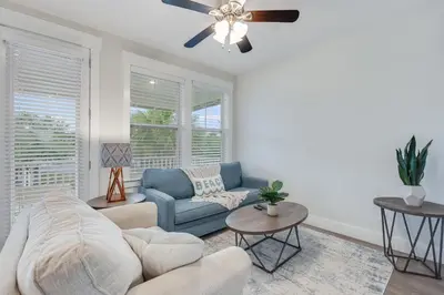 a living room with a couch and a ceiling fan at Coastal Sands - 219 Sands Street in Panama City Beach