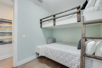 a bedroom with a bunk bed and a ladder at Coastal Sands - 219 Sands Street in Panama City Beach