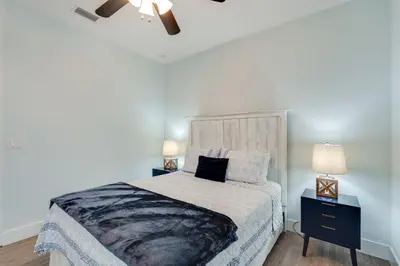 a bedroom with a large bed and two night stands at Coastal Sands - 219 Sands Street in Panama City Beach