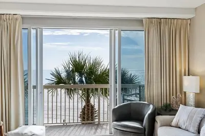 a living room with a couch and a large window at Celadon 109 - 3BR 3BA in Panama City Beach