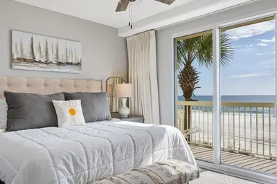 a bedroom with a bed with a view of the ocean at Celadon 109 - 3BR 3BA in Panama City Beach