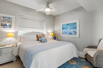 a bedroom with a bed with a teddy bear on it at Celadon 109 - 3BR 3BA in Panama City Beach