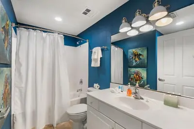 a bathroom with a white sink and a toilet at Celadon 109 - 3BR 3BA in Panama City Beach