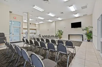a conference room with chairs and a flat screen tv at Celadon 109 - 3BR 3BA in Panama City Beach