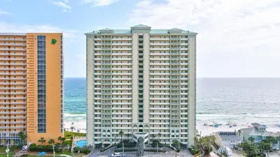 a large building next to the ocean with the ocean behind it at Celadon 109 - 3BR 3BA in Panama City Beach