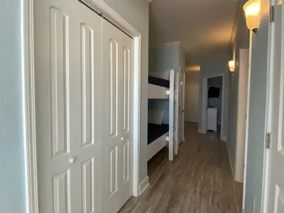 a hallway with a door leading to a bedroom at Celadon 207 beachfront 1 BR 2 BA Sleeps 6 in Panama City Beach