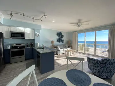 a kitchen and living room with a view of the ocean at Celadon 207 beachfront 1 BR 2 BA Sleeps 6 in Panama City Beach