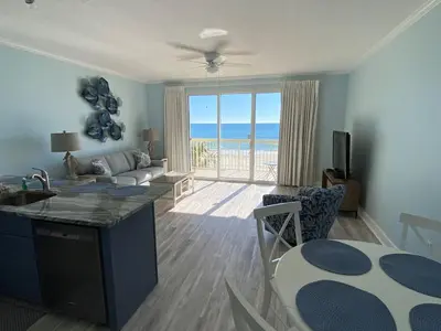 a living room with a view of the ocean at Celadon 207 beachfront 1 BR 2 BA Sleeps 6 in Panama City Beach