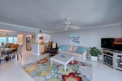 a living room with a couch and a flat screen tv at Mariner East #201 1 BR 2 BA Amazing Balcony! in Panama City Beach