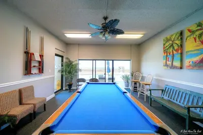 a room with a pool table in the middle at Mariner East #201 1 BR 2 BA Amazing Balcony! in Panama City Beach