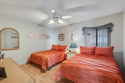a bedroom with two beds and a ceiling fan at Watercrest 1603 - 2 BR 2 BA Beachfront Balcony in Panama City Beach