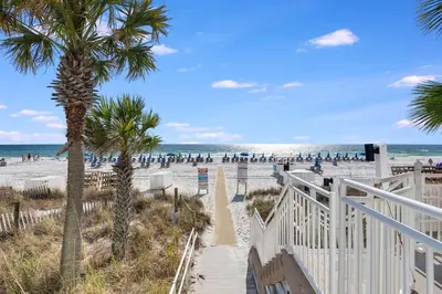 a view of a beach with palm trees and the ocean at Watercrest 1603 - 2 BR 2 BA Beachfront Balcony in Panama City Beach