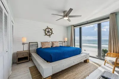 a bedroom with a bed and a large window at Watercrest 408 - 2BR 2BA - Emerald Gulf Paradise in Panama City Beach