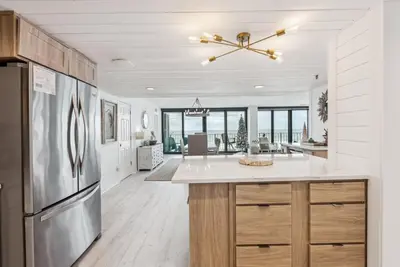 a kitchen with a stainless steel refrigerator and a counter at Watercrest 408 - 2BR 2BA - Emerald Gulf Paradise in Panama City Beach