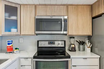 a kitchen with a microwave and a stove top oven at Watercrest 408 - 2BR 2BA - Emerald Gulf Paradise in Panama City Beach