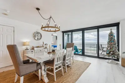 a dining room with a table and chairs and a christmas tree at Watercrest 408 - 2BR 2BA - Emerald Gulf Paradise in Panama City Beach