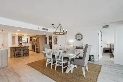 a dining room and kitchen with a table and chairs at Watercrest 408 - 2BR 2BA - Emerald Gulf Paradise in Panama City Beach