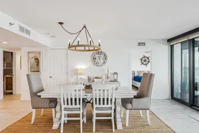 a dining room with a white table and chairs at Watercrest 408 - 2BR 2BA - Emerald Gulf Paradise in Panama City Beach