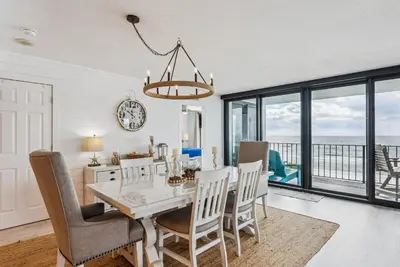 a dining room with a table and chairs at Watercrest 408 - 2BR 2BA - Emerald Gulf Paradise in Panama City Beach