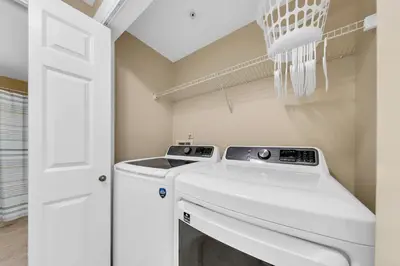 a laundry room with a washer and dryer at Boardwalk 2101 in Panama City Beach