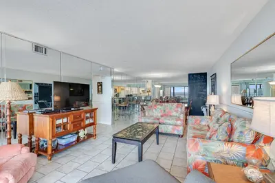 a living room with couches and a table at 5th Floor Oceanview Getaway - Moondrifter in Panama City Beach