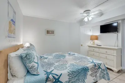 a bedroom with a bed and a ceiling fan at 5th Floor Oceanview Getaway - Moondrifter in Panama City Beach