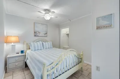 a bedroom with a bed and a ceiling fan at 5th Floor Oceanview Getaway - Moondrifter in Panama City Beach