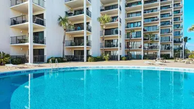 a swimming pool in front of a apartment building at 5th Floor Oceanview Getaway - Moondrifter in Panama City Beach