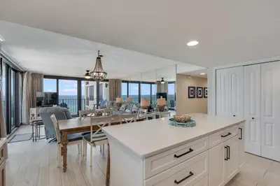 a kitchen and dining room with a view of the ocean at Watercrest 901 2 BR 2 BA sleeps 8 Amazing balcony! in Panama City Beach