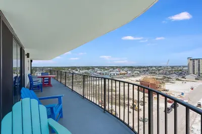 a balcony with blue chairs and a view of a city at Watercrest 901 2 BR 2 BA sleeps 8 Amazing balcony! in Panama City Beach